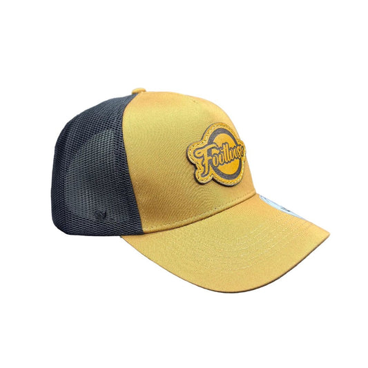Tan and black cap with a logo on a white background